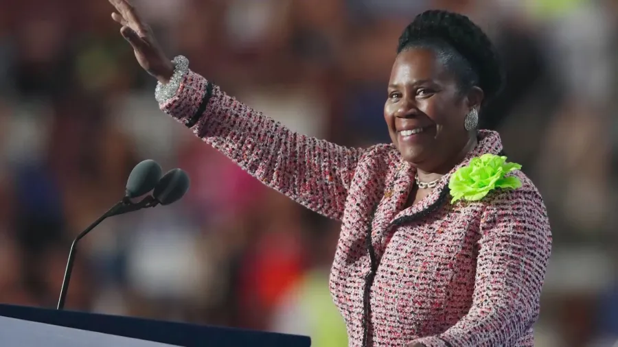 Sheila Jackson Lee waves to a crowd during a speech.